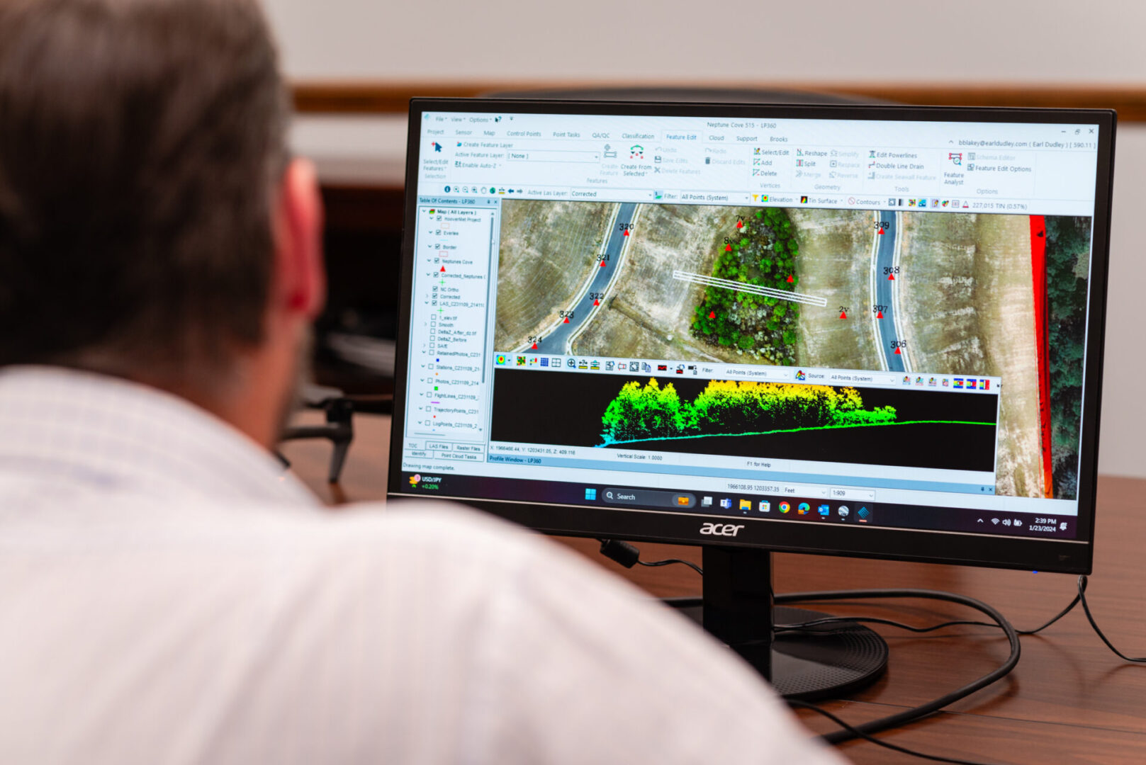 A man looking at an image on the computer screen.