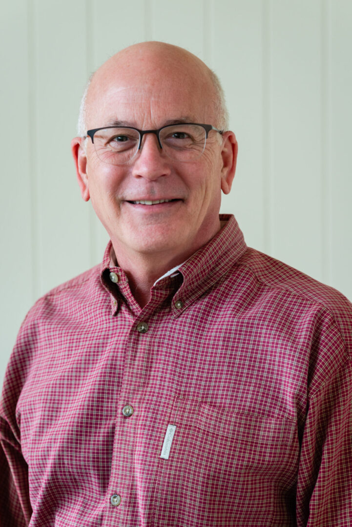 A man in glasses and a red shirt